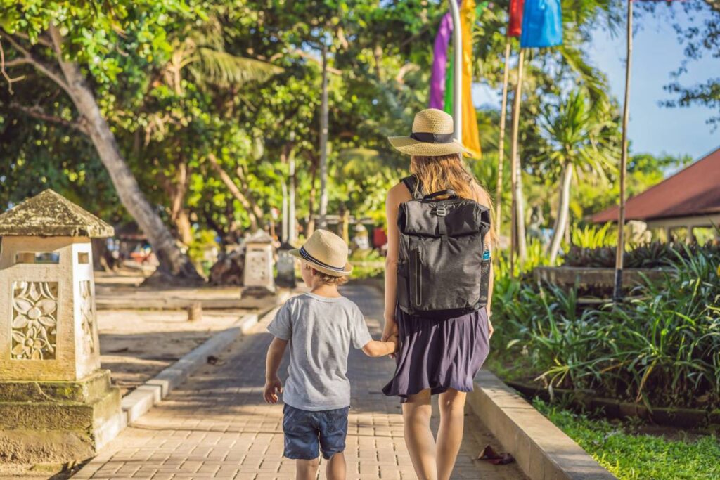 Mother and child walking along the beach path in Sanur, Bali