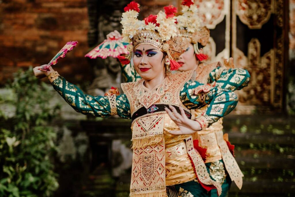 Traditional Balinese dancer in ceremonial dress performing temple dance