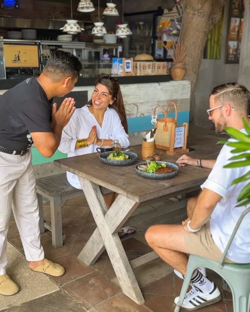 Couple enjoying a healthy meal and warm hospitality at a local café in Sanur during a yoga retreat in Bali